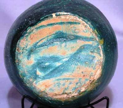 early-north-carolina-art-pottery-bottom The condition of this particular vase, made in the 1920s, is good, but has numerous nicks to the rim, a small ding to the body, and rub on the base. The lower portion shows lime deposits in the crazing.