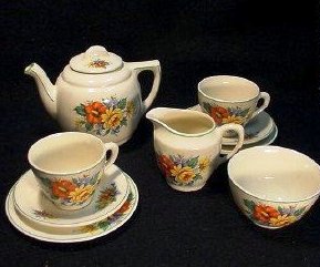 1940s-childe28099s-tea-set A 9-piece child’s tea set with a floral pattern and bright colors with green banding produced in England under the conditions set by the British Board of Trade.