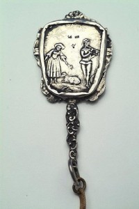 800 Silver ChatelainePurse Mirror 19th C back The back of the mirror shows an idealized European pastoral scene of shepherdess, two sheep and gentleman with pan pipes.