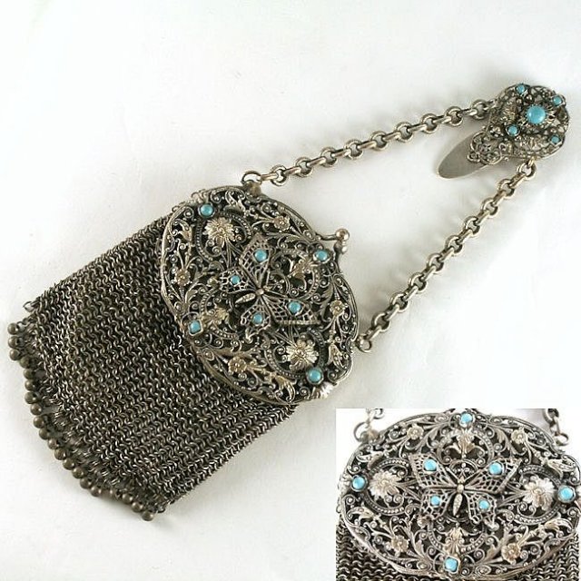 Chatelaine Chain Mail Purse With Belt Clip, Ornate Filigree Top Butterfly, Turquoise Beads . This châtelaine chain mail purse has dangling steal beads on the bottom for various attachments and an interior mirror with the original green silk liner. A silver filigree top features a matching belt clip that also has Turquoise beads. Circa 1850.
