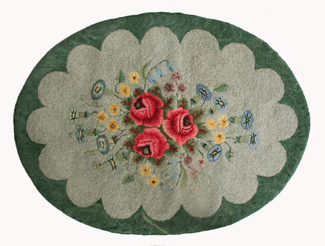 Hooked Rug b Hand hooked oval rug made of wool on burlap in floral design, circa 1940.