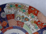 image0092.jpg An Imari porcelain plate with old repairs and rim chips that are easily visible to the naked eye.