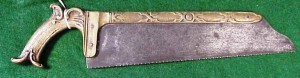 00-3-15 This is an unusual tenon-style amputation saw with a very decorative brass handle and spine, circa.1850.