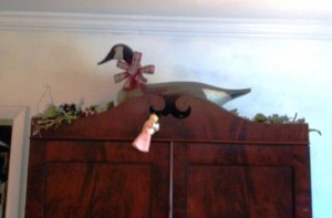 blogdecoydecor2 A big bow on the goose is very festive for Christmas. This goose is a Madison Mitchell Canada Goose on top of an Alabama made 1840’s secretary.
