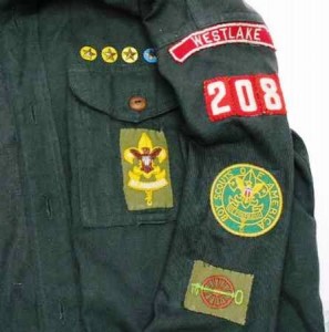 1953-54-boy-scout-shirt-and-patches This green long-sleeved Boy Scout shirt, dating from the 1954, displays several patches and pins, including a Westlake “red and white” council name patch, a key and a wheel patch, a rank patch and service pins.