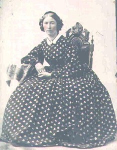 dress2 Early 1860s plain dress with large, round hoop, buttons down the front, tight cuffs and a tiny white collar.