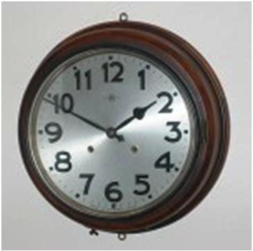 oj-fig-12 An example of a fine-quality wall clock that strikes on the hour and half-hour, with a 15-inch overall diameter. The maker’s logo is a capital “H,” just below the 12, while the printed “MIOJ” is below the 6.