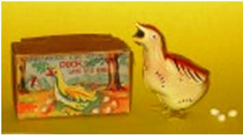 oj-fig-13 A most ingenious wind-up toy duck that lays eggs. The celluloid eggs are loaded into the mouth and after winding it up, the duck waddles around and lays the eggs. The toy is more valuable because of the original box, but in this case it’s essential because the MIOJ mark is only on the box. The Duck carries the name Japan under its wing.