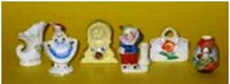 oj-fig-9 Porcelain miniatures, standing 2 ½ inches tall, of a shell, dancing girl, clock, toothpick holder, bag and Oriental vase.