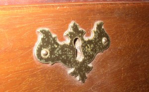 This Chippendale batwing escutcheon is from the 1940s.