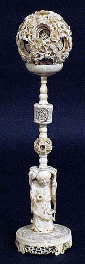 ivory-ball2 This ivory concentric ball (Chinese, circa 1850) with chrysanthemums containing approximately twelve inner loose balls with pierced trellis design, supported by the stand with a standing boy holding a peach, sold for $2,150.