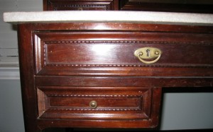 This desk drawer combines a drawer pull with an escutcheon.