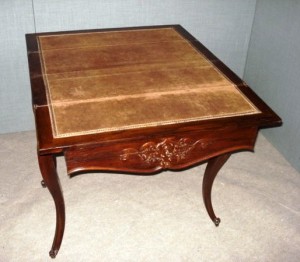 table-fold-over-french-as-227 A 19th-century rosewood fold-over continental card table, standing on slender cabriole legs, with carvings to the toes. The table is fitted with carved center drawer, fitted with a lock and key. The open top is lined with brown baise.