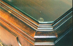 704-24 A piece of glass almost always has a microscopically thin layer of moisture on the surface. This moisture will “grow” to the finish on furniture sticking the glass to the piece resulting in finish damage when the glass is removed. Allowing air to circulate under the glass using spacers like this clear disc eliminates that problem.