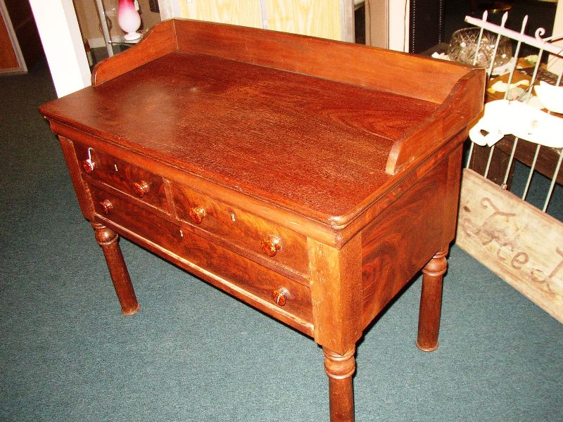 work-table This contraption of a kitchen work table is the top two drawer section of an Empire-period chest, legs from who knows what, and a walnut top that has been made to fit. This is more than just a marriage!