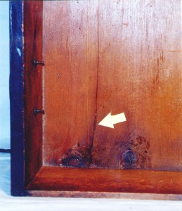 Drawer bottom This “crack” in the drawer bottom is caused by the wood shrinking across the grain. That means the bottom panel is improperly secured in the drawer, probably due to over enthusiastic restoration.