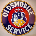 Oldsmobile Service Oldsmobile Service 42-inch double-sided porcelain sign with crest logo and great gloss was hammered at $5,170.
