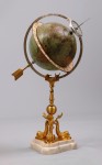 Juvet globe clock This Juvet table-top clock with 11-inch globe and gilt bronze 3-dolphin base, mounted on marble, sold for $24,150.