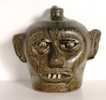Meaders Hand-turned china plate teeth face jug by Lanier Meaders, crafted in 1968, with tobacco-split glaze.