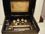 Music box Vintage cylinder music box (circa 1880s), with bells and butterflies and bees inlay, in rosewood case.