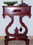 Rococo repro This nice little end table looks like a subtle mixing of Empire and Rococo Revival, a frequently seen combination in the 1850s. However, this table is a reproduction piece, made in the 1960s.
