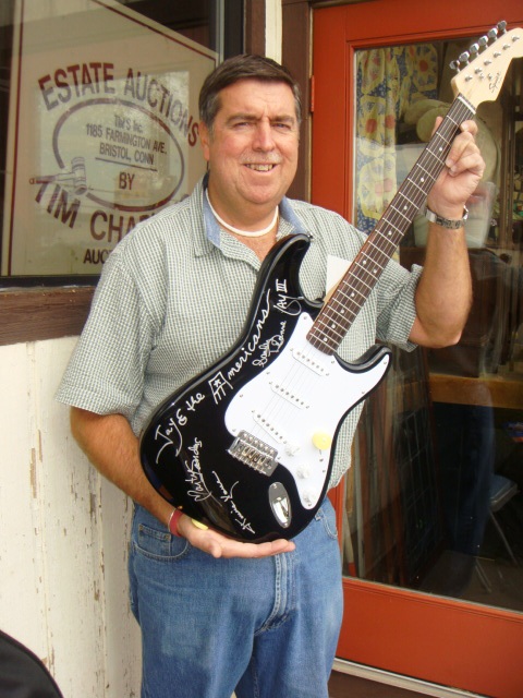 Tim with guitar Auctioneer Tim Chapulis with a guitar signed by the members of the rock group Jay & the Americans, just one of several pieces of rock ‘n’ roll memorabilia items to go up for auction to benefit the Litchfield Firehouse.