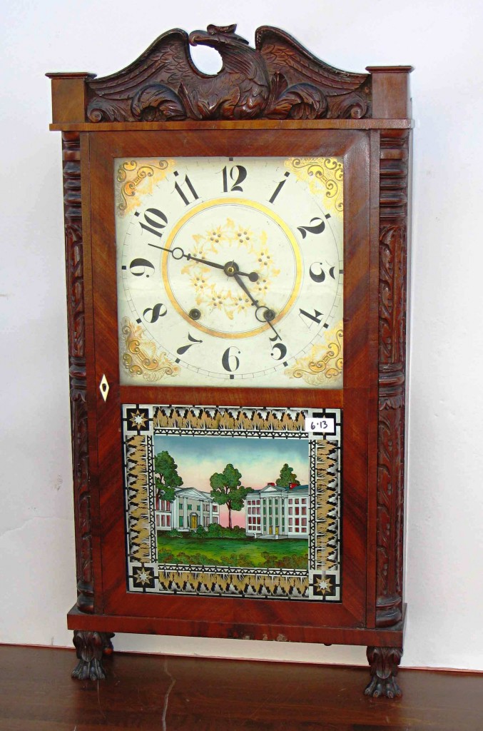 Eli Terry, Jr. A carved case shelf clock by Eli Terry, Jr., featuring carved quarter columns flanking the full-length door, which has a reverse painted glass below the glazed square wood dial and carved paw feet, will be one of the featured items in a two-day auction hosted by Gordon S. Converse & Co. on Dec. 28, 2009.
