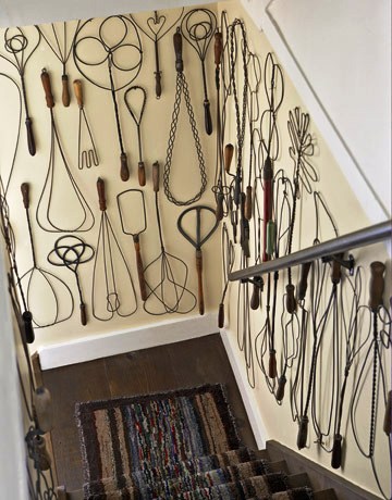 rug-beater-collection-de-70218515 A collection of vintage rug beaters are displayed on the walls of the staircase. Don’t constrict where you display your collections by sticking to shelves.