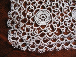 tatting2 Close-up of the handkerchief showing the intricate detail of the tatting. The round loops on the edge of the chain are picots, which are typical of tatting.