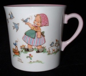 Shelley Mabel Lucie Atwell Mug Little Blue Bird Signed A piece of Shelley’s Nursery Ware line, featuring a little girl with birds and the verse “Little Blue Bird, How He Sings—So Happy On My Plates And Things”