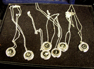 Necklace An assortment of necklaces featuring typewriter keys.
