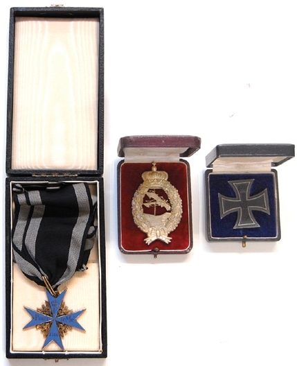 Tutschek awards The Von Tutschek lot consisted of his original Pour Le Merit “Blue Max” (left), his engraved cut-out pilot’s badge (center) and his silver Iron Cross medal.