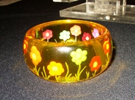 Vibrulite A cast acrylic bangle with back carving and inlay.