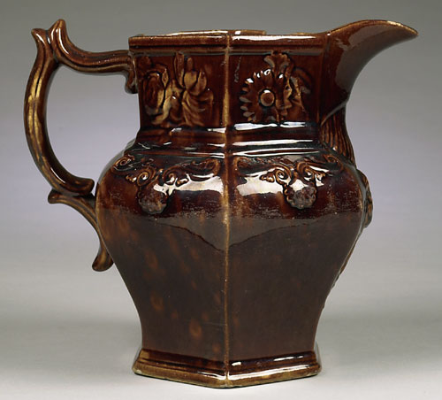 pottery William Bromley This wonderful Cincinnati yellow ware paneled water pitcher with Rockingam-type mottled brown glaze on a slip-cast body was made by William Bromley. The pitcher has floral scrollwork decoration and a female with harp below spout. The base has impressed Eagle mark with “Bromley & Co. Brighton Pottery Cin. Ohio.”