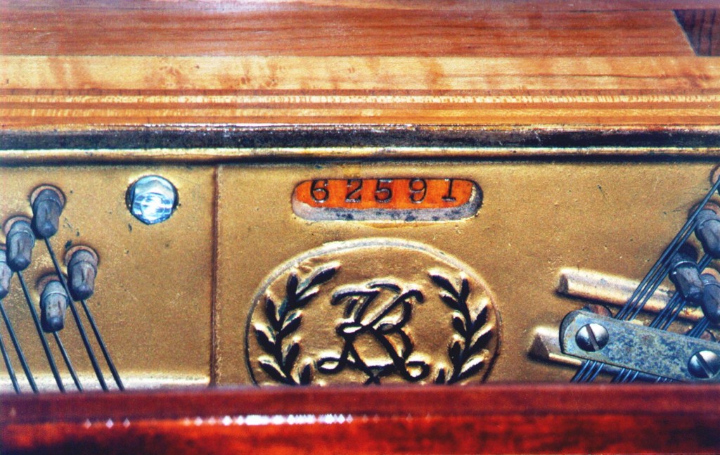 177-19 The serial number of this piano is stamped into the soundboard and surrounded by the cast plate. It belongs to a Krakauer Brothers mahogany console made in 1946 using new post war plastic technology in the action.