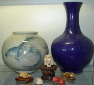 Porcelains Items from Asia, including porcelains, 19th century Roulade vase, blue with carp, and 15-inch Chiang Long altar vase, will be sold with no reserve.