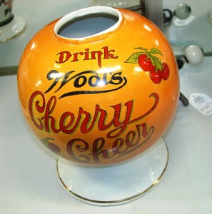 Wool's Cherry Cheer A Wool’s Cherry Cheer soda fountain syrup dispenser in pumpkin color, possibly one of a kind.