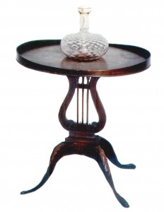 Mersman A Mersman Colonial Revival “surf board” lamp table features a lyre base popular in the Federal and Empire period of the early 19th century. (Courtesy Swedberg, “Furniture of the Depression Era,” Collector Books)