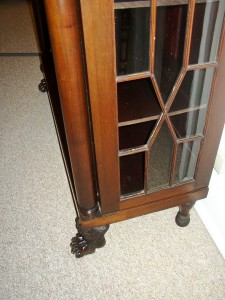 Missing glass This Empire chain cabinet is missing two of the original panes of glass.