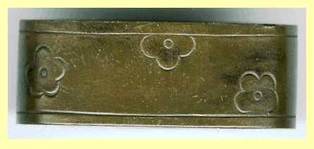 A fuchi encircles the top of the handle of a sword, where the blade enters. This fuch is in the design of a plum blossom