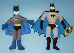Two plush Batman dolls. The one on the left is from an unknown manufacturer; the one on the right (from Batman The Animated Ser