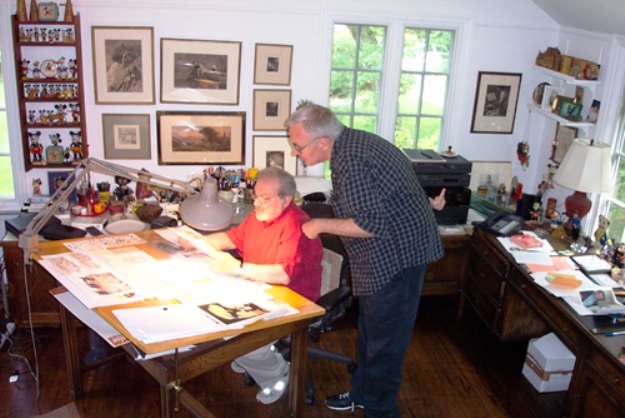 Sendak at work in his home studio. Evidence of his Mickey Mouse collection is on the shelf to the left of his desk.