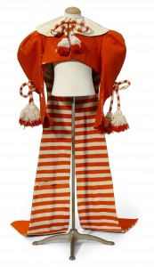 An orange Munchkin jacket from the “Wizard of Oz” will bring no small price; the auction house estimates it will bring between $8,000 and 12,000. (Photo: Bonhams)